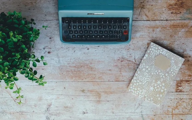 vintage, typewriter, plant, book, notebook, notepad, table top, retro, nature, vintage typewriter. How to build a personal essay from one consequential moment