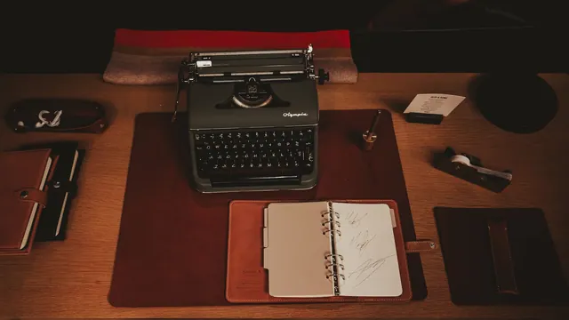 A desk with a typewriter, notebooks, and pen. How to build a claim-evidence-source note system