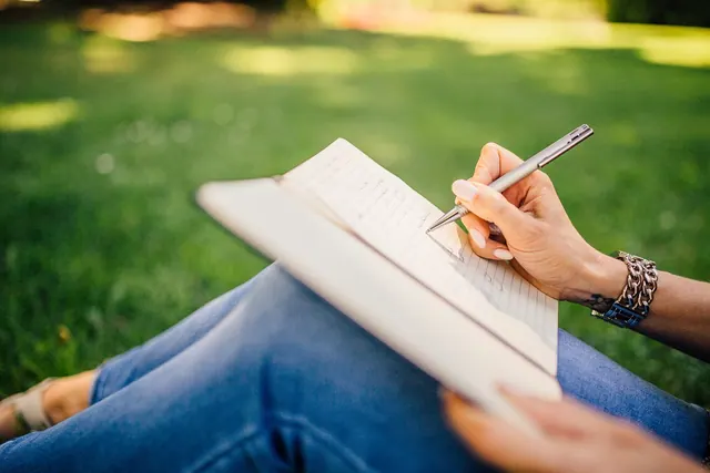 writing, writer, notes, pen, nature, notebook, book, girl, woman, people, hands, grass, outdoors. Logical fallacy problems: straw men, false choices and weak causation