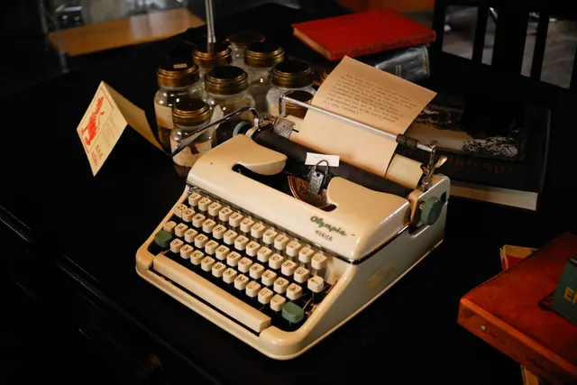 A nostalgic scene of a vintage typewriter and books on a dimly lit desk, evoking a retro feel. Rebuilding a shapeless first draft into a focused essay: a worked case